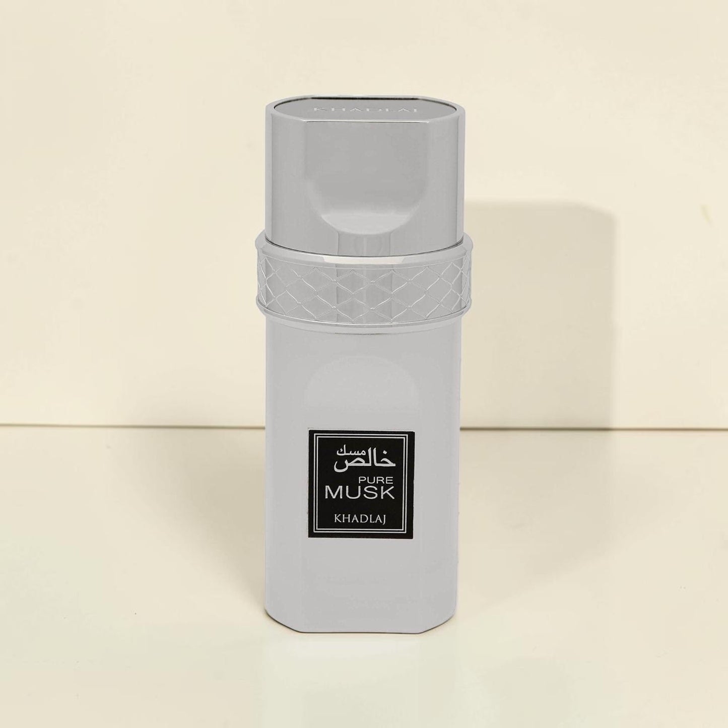 Oud Sera Khadlaj Pure Musk perfume bottle in a sleek silver metallic finish with a textured cap detail.